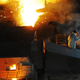 A worker pries up molten cast iron from a blast furnace at a plant of Dongbei Special Steel Group on July 17, 2018 in Dalian, Liaoning Province of China.